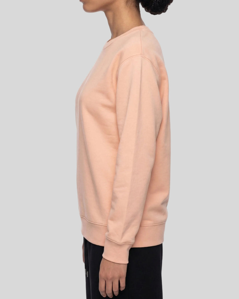 Upper body side view of woman wearing oversized Everyday Sweatshirt in Pink