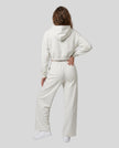 Full-body back view of a model wearing the Everyday Straight Leg Sweatpants in Oat Gray