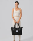 Model carrying ExpandForm Weekender Bag in black styled for studio sessions and everyday movements