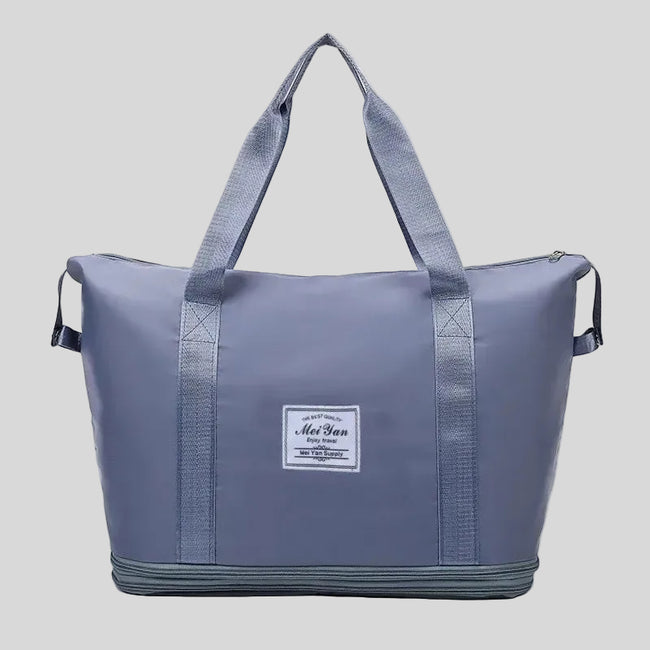 ExpandForm Weekender Bag in dusty blue front view with structured silhouette and dual handles