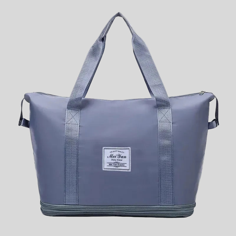 ExpandForm Weekender Bag in dusty blue front view with structured silhouette and dual handles