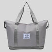 ExpandForm Weekender Bag in gray front view with structured silhouette and dual handles