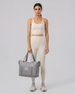 Model carrying ExpandForm Weekender Bag in lavender styled for studio sessions and everyday movements