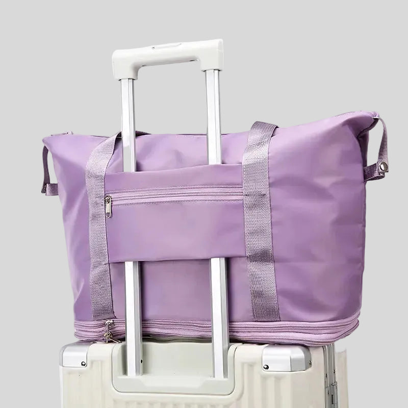 ExpandForm Weekender Bag attached to luggage handle with back strap for travel convenience