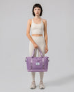 Model carrying ExpandForm Weekender Bag in lavender styled for studio sessions and everyday movements