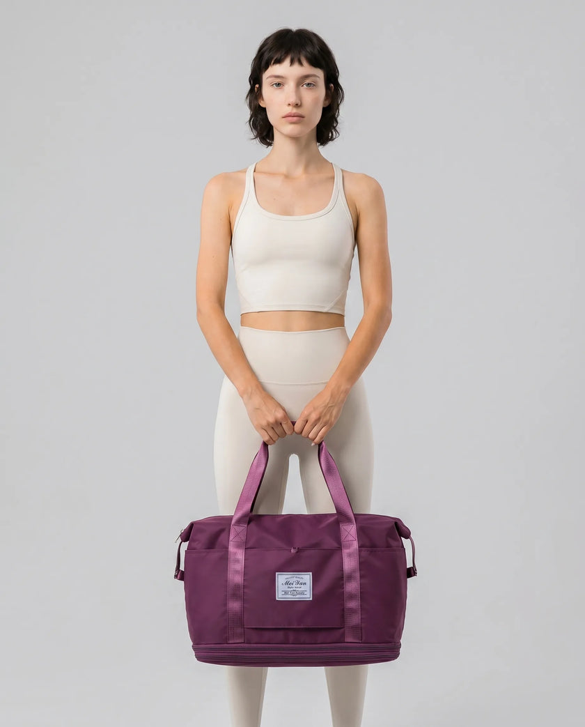 Model carrying ExpandForm Weekender Bag in plum purple styled for studio sessions and everyday movements