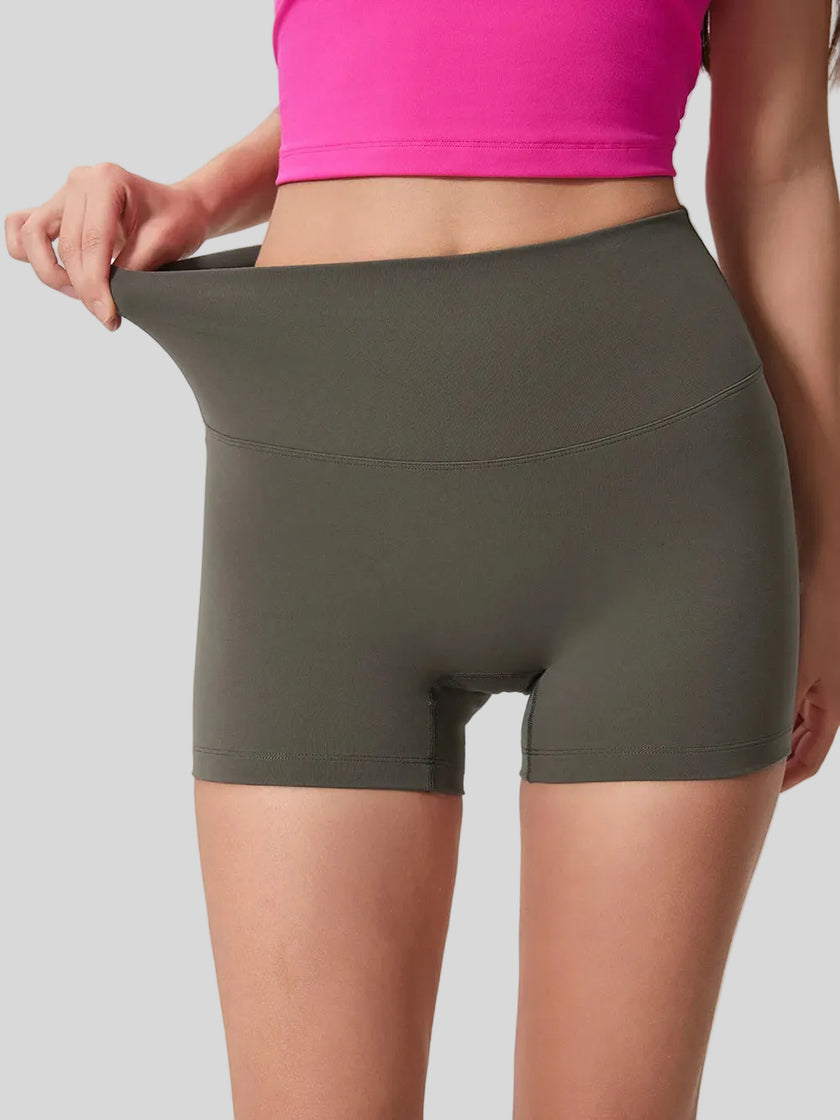 Smooth, stretchy fabric of FlexRise High-Waist Short Legging in Deep Dark Green - Athlesi