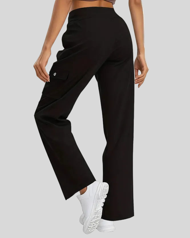 Back angled view of FlowCargo Relaxed Active Pants in Black showing relaxed silhouette and waistband fit