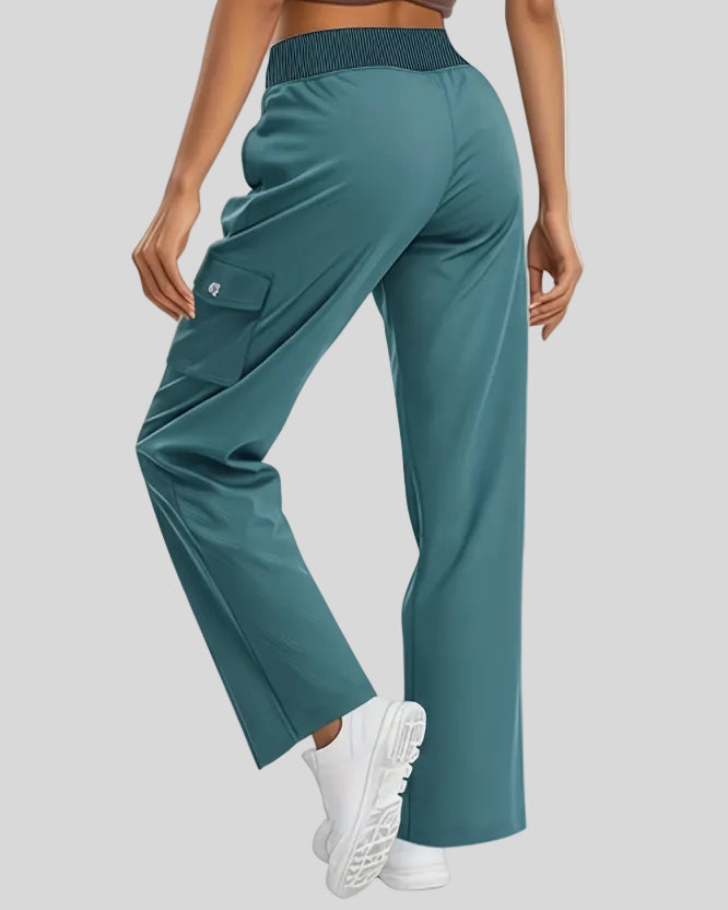 Back angled view of FlowCargo Relaxed Active Pants in Sea Blue showing relaxed silhouette and waistband fit