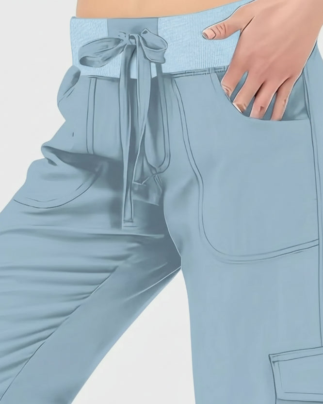 Close-up of drawstring waistband and front pocket detail on FlowCargo Relaxed Active Pants in Sky Blue.