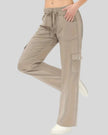 FlowCargo Relaxed Active Pants in Tan shown from a front angled view with drawstring waist and relaxed fit.