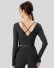Athlesi FlowCross studio top in black featuring crisscross back detail