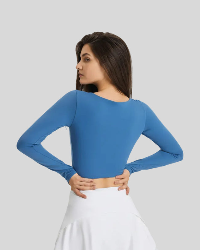 Back view of blue FlowCut Studio Top with smooth fitted silhouette
