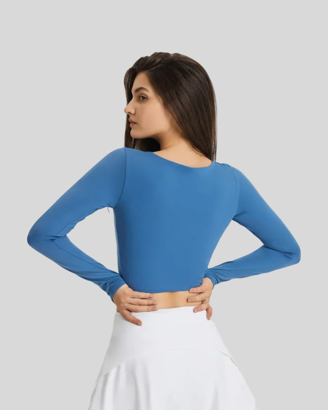 Back view of blue FlowCut Studio Top with smooth fitted silhouette