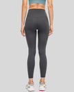 Back view of dark gray FlowEase High-Waist Pocket Legging with seamless silhouette