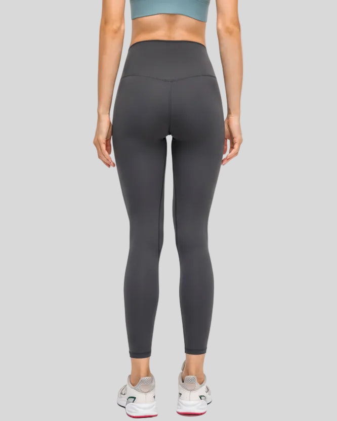 Back view of dark gray FlowEase High-Waist Pocket Legging with seamless silhouette