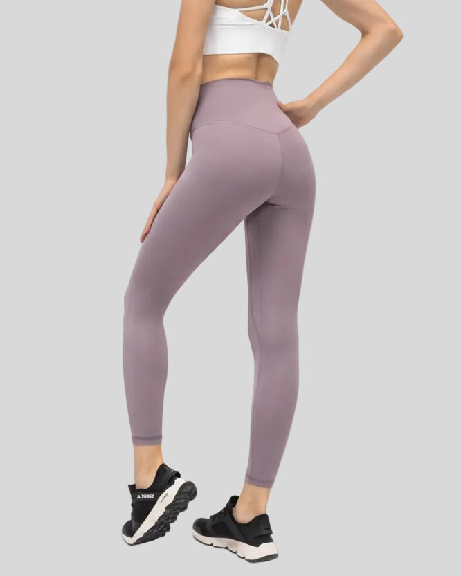 Back angle view of pink purple FlowEase High-Waist Pocket Legging with seamless silhouette