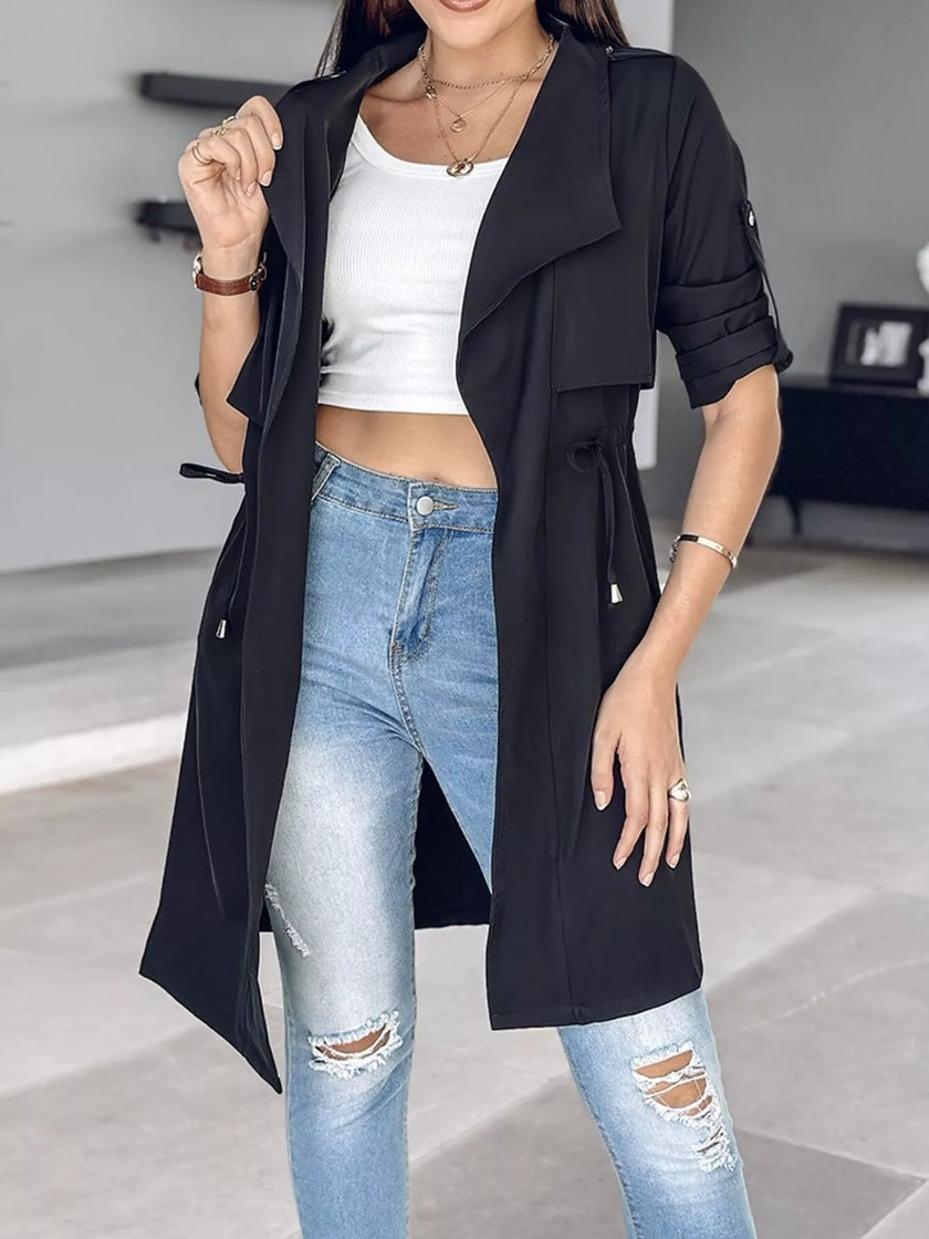 Athlesi FlowForm trench black angled front view highlighting drape collar and relaxed fit