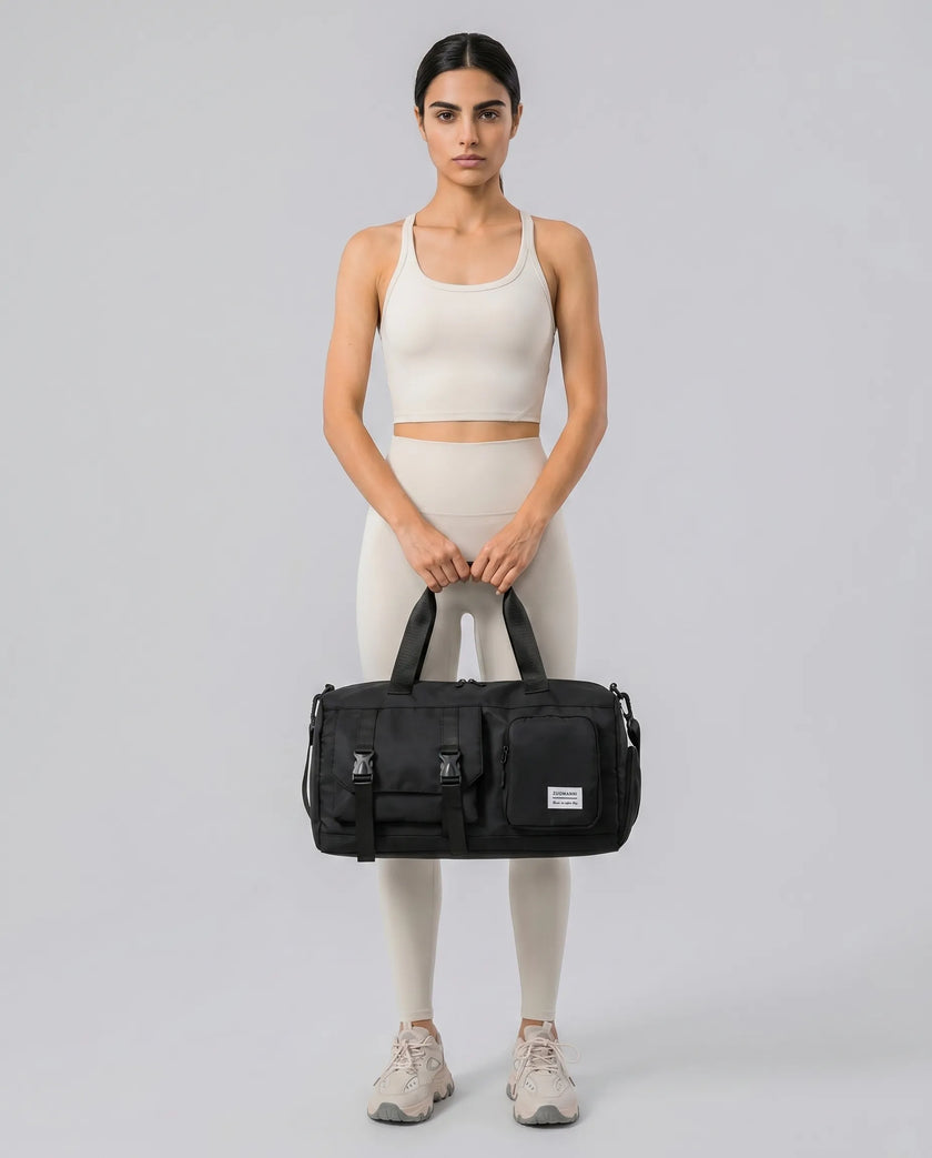 Model holding a black FlowHold Carry Bag in front with both hands styled for everyday movement