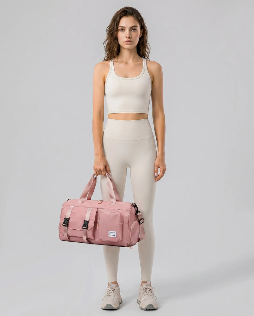 Model holding a burnt coral FlowHold Carry Bag in front with both hands styled for everyday movement