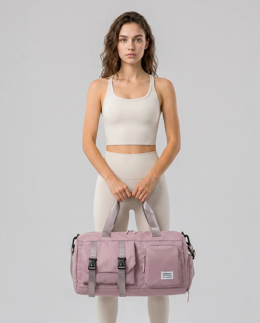 Model holding a dusty pink FlowHold Carry Bag in front with both hands styled for everyday movement