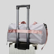 FlowHold Carry Bag attached to suitcase using back luggage strap