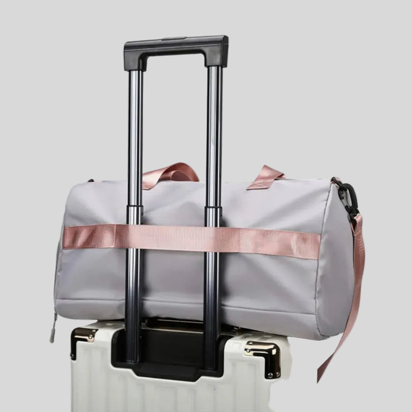 FlowHold Carry Bag attached to suitcase using back luggage strap