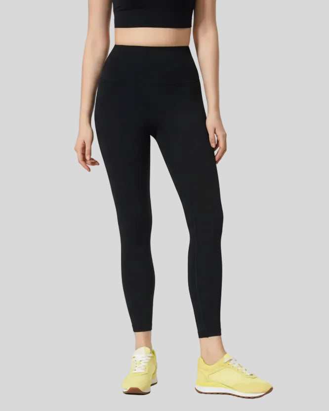 Front angle view of black FlowLine Core Legging with wide waistband