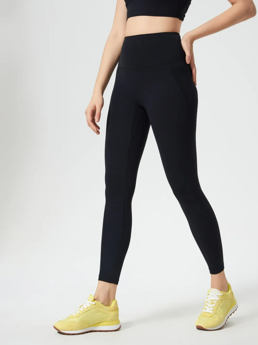 Left side view of black FlowLine Core Legging with smooth silhouette