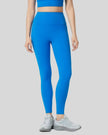 Front angle view of blue FlowLine Core Legging with wide waistband