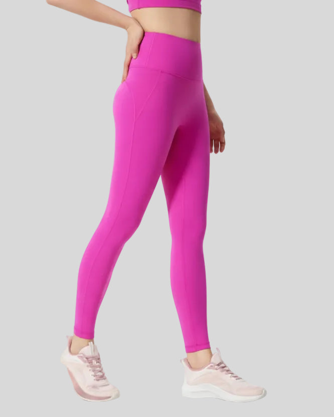 Right side view of FlowLine Core Legging in fuchsia pink