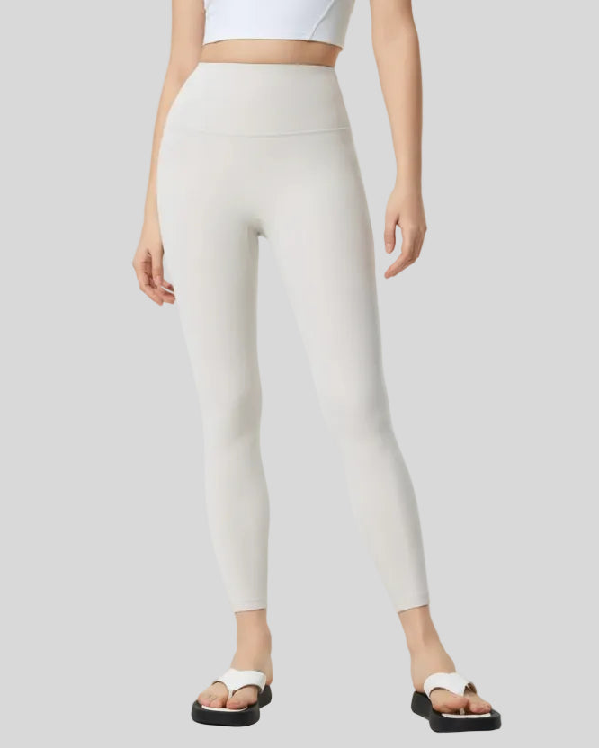 Front angle view of white FlowLine Core Legging with wide waistband