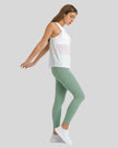 Side view of Athlesi FlowLine Core legging in gum leaf