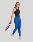 Angled front view of Athlesi FlowLine Core legging in peacock blue