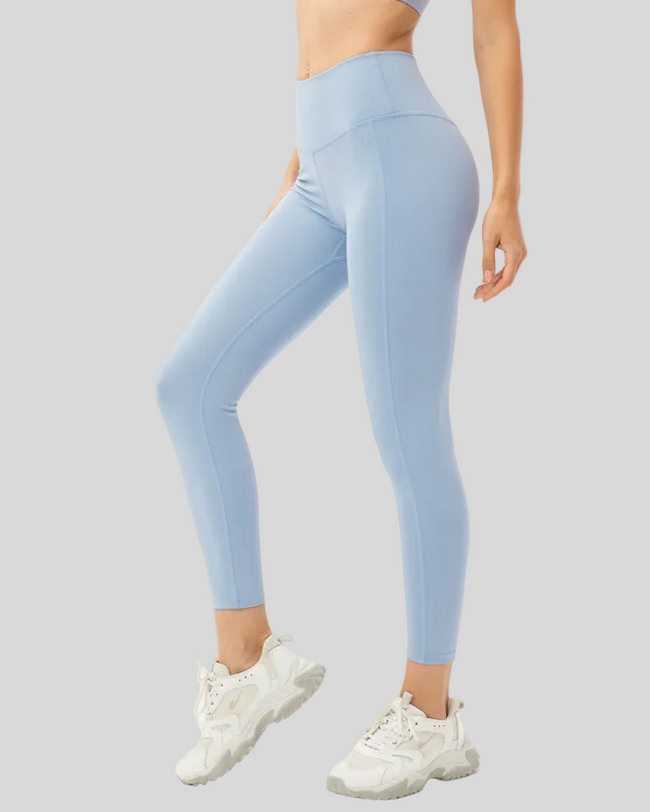 Light blue FlowLine Core Smooth leggings worn by a woman on a gray background