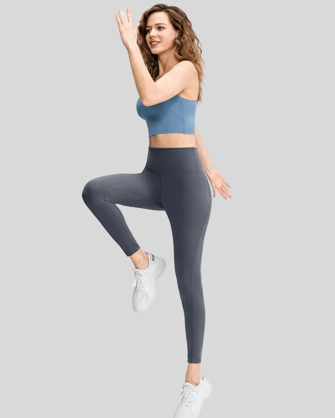 Full body front angle view of FlowLine Hold Legging in dark gray with slim fit silhouette