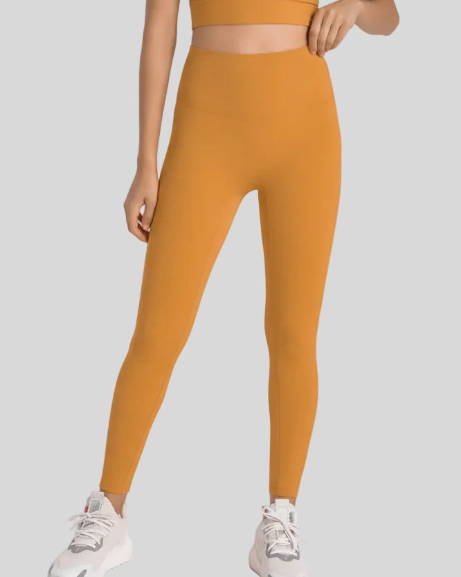 Body-hugging silhouette of FlowLine Hold Legging in Tangerine - Athlesi