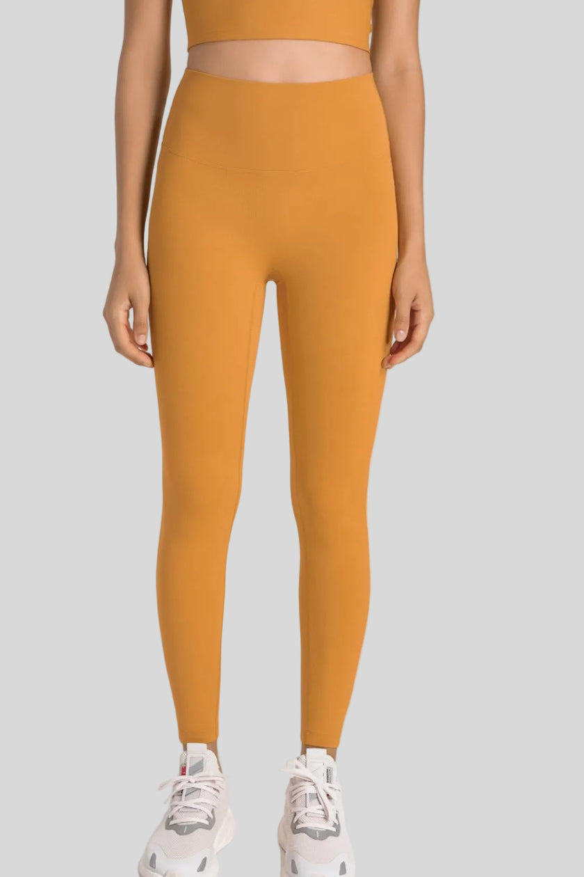 High-rise waistband of FlowLine Hold Legging in Tangerine - Athlesi