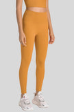 Smoothing fit of FlowLine Hold Legging in Tangerine - Athlesi