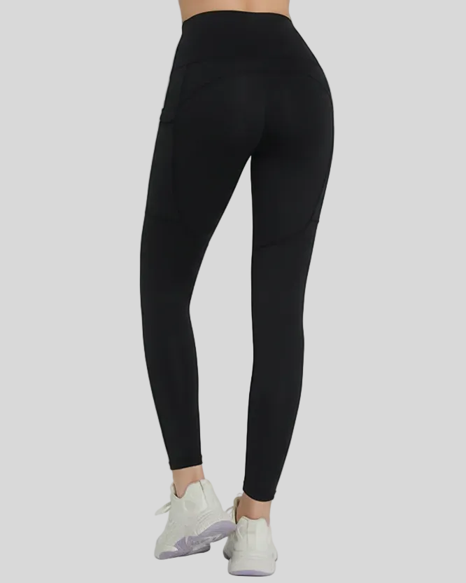 Black Flowline Hold Pocket leggings worn by a woman on a gray background