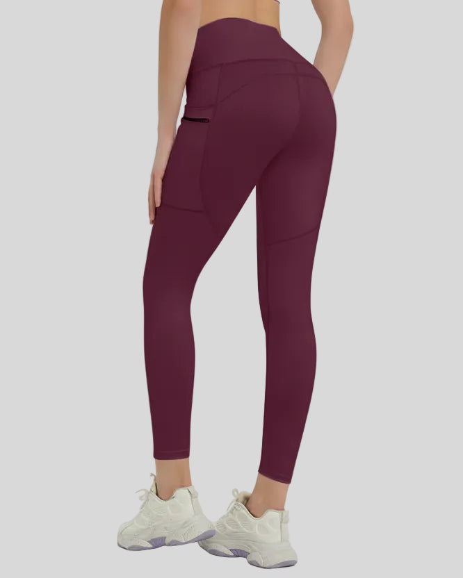 Back view showing a streamlined fit and refined construction of the FlowLine Hold Pocket Legging in burgundy