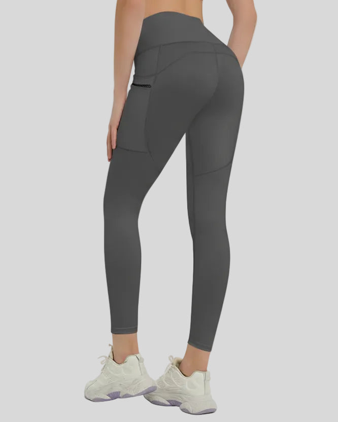 Back view showing a streamlined fit and refined construction of the FlowLine Hold Pocket Legging in dark gray
