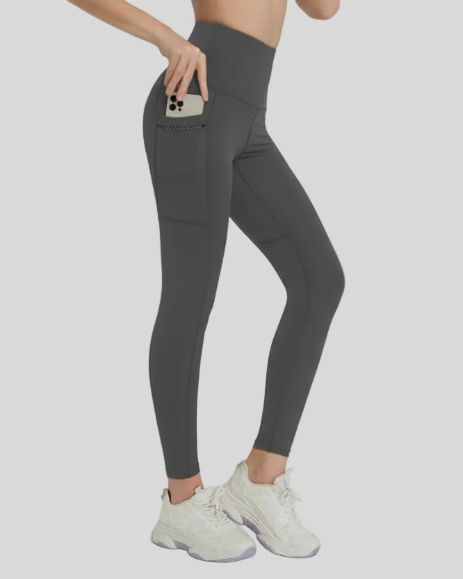 Side view highlighting the discreet pocket design and smooth, urban finish in dark gray