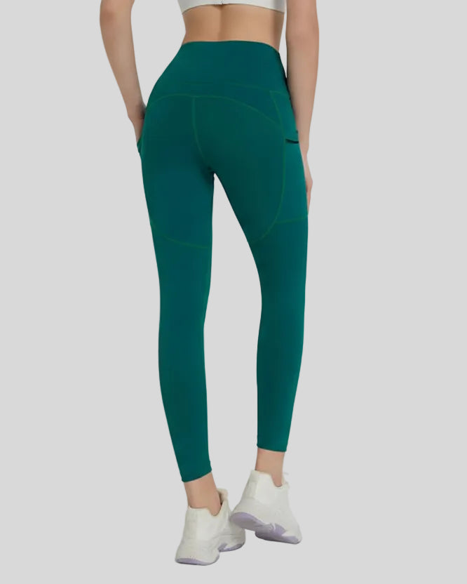 Back view showing a streamlined fit and refined construction of the FlowLine Hold Pocket Legging in dark green