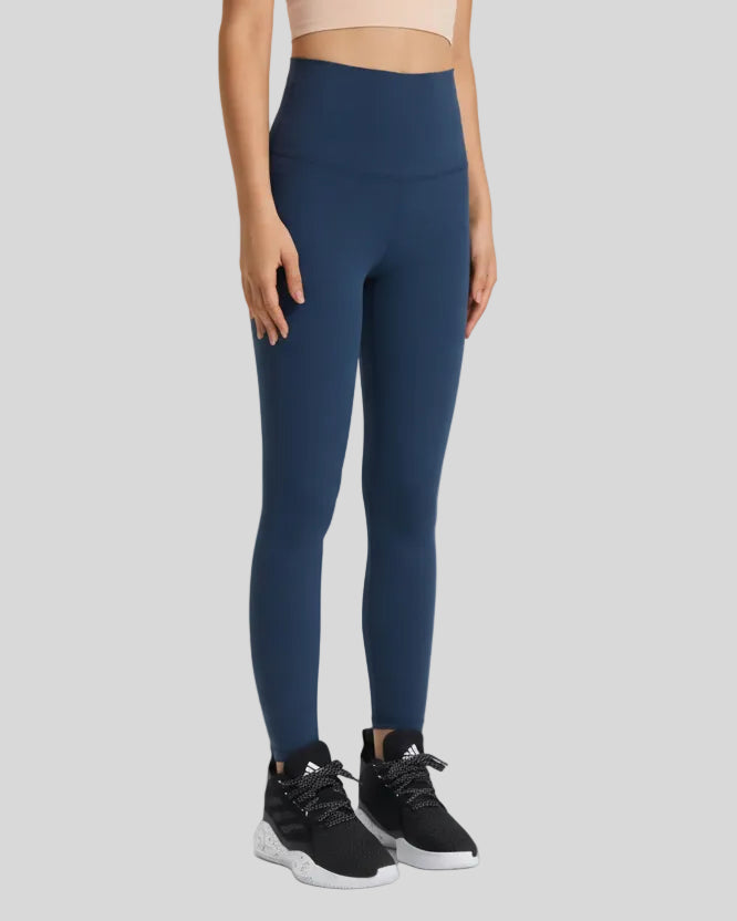Front angle view of FlowLine Hold Soft Legging in navy with fluid silhouette