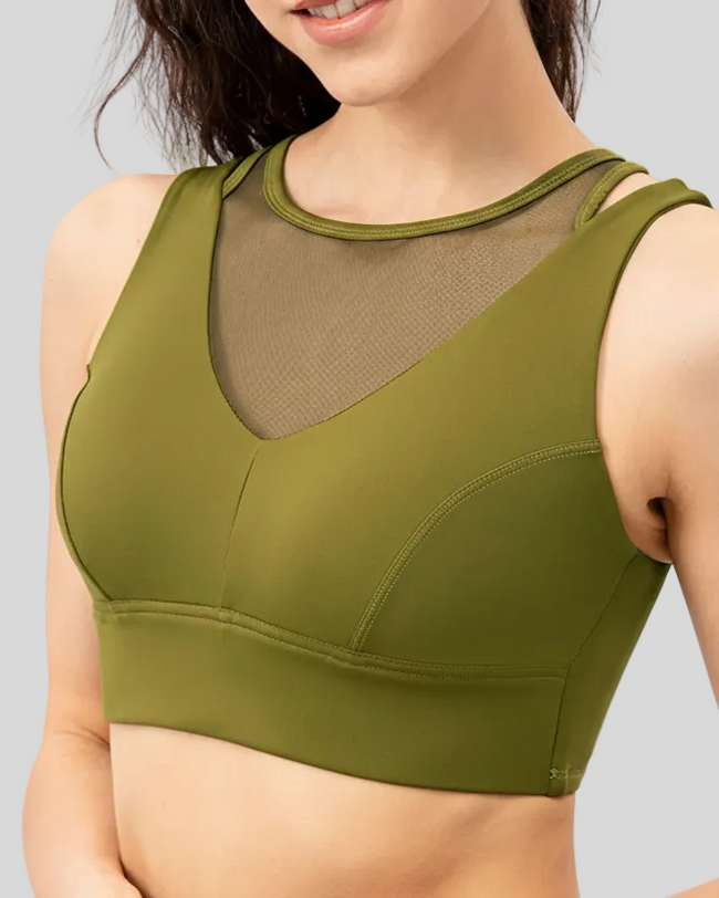 Green sports bra worn by a person on a white background