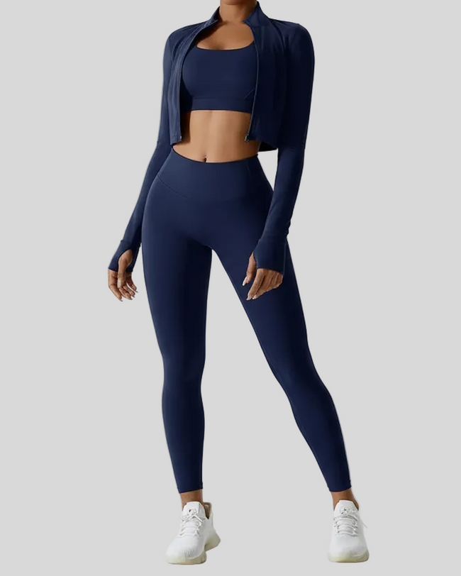 Model wearing a navy blue athletic outfit on a light gray background