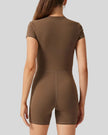 Back view of FlowZip short-sleeve romper in brown with clean, fitted silhouette