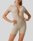 FlowZip short-sleeve romper in tan with half-zip front and streamlined fit