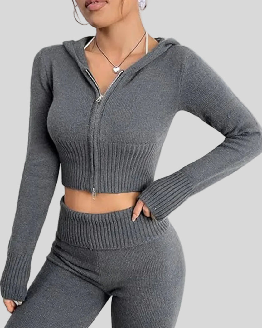 Angled upper body view of model wearing dark gray Athlesi FormFlare hoodie and flare pant set